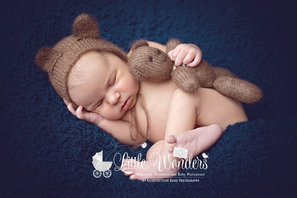 Affordable Houston Kingwood Newborn Baby Maternity Photographer by Little Wonders Portraiture- baby holding teddy bear on blue blanket