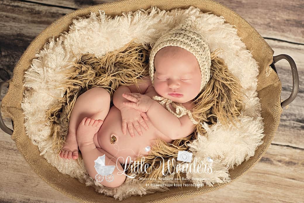Kingwood Newborn Portraits- Baby in a basket with hat.