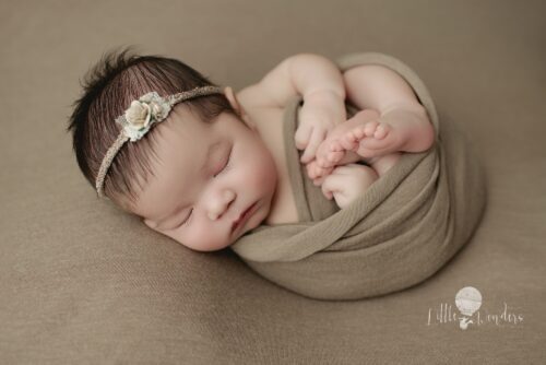 newborn baby in huck finn poses for first time newborn photography clients
